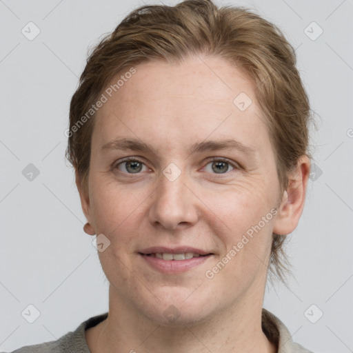 Joyful white adult female with short  brown hair and grey eyes