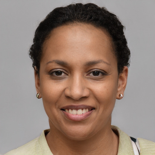 Joyful latino young-adult female with short  brown hair and brown eyes