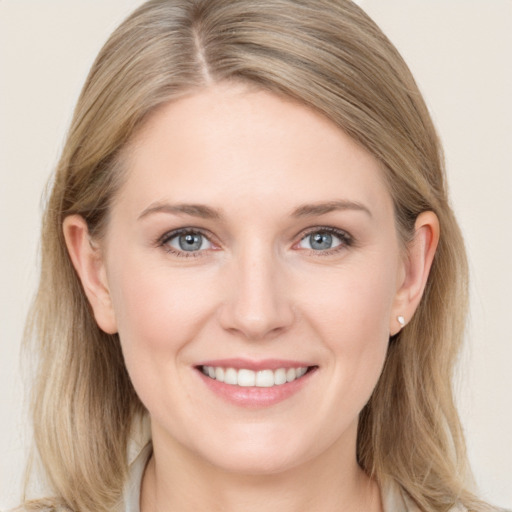 Joyful white young-adult female with medium  brown hair and blue eyes