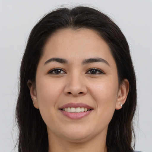 Joyful latino young-adult female with long  brown hair and brown eyes