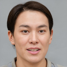 Joyful asian young-adult male with short  brown hair and brown eyes