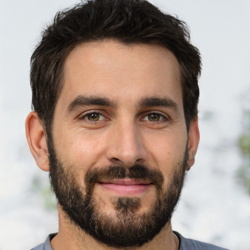 Joyful white adult male with short  brown hair and brown eyes