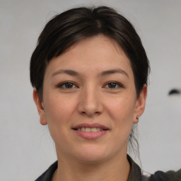 Joyful asian young-adult female with medium  brown hair and brown eyes