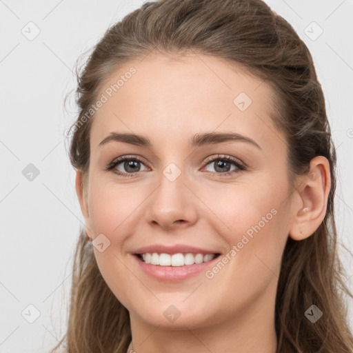 Joyful white young-adult female with long  brown hair and grey eyes