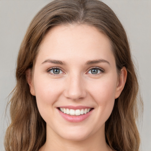 Joyful white young-adult female with medium  brown hair and green eyes