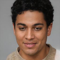 Joyful latino young-adult male with short  brown hair and brown eyes