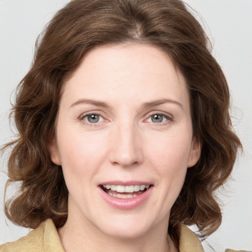 Joyful white young-adult female with medium  brown hair and green eyes