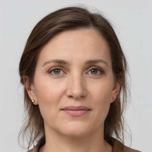 Joyful white young-adult female with medium  brown hair and grey eyes