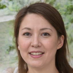 Joyful white adult female with medium  brown hair and brown eyes