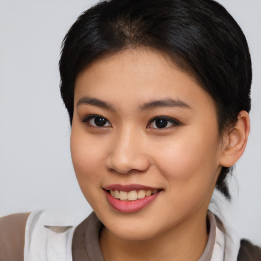 Joyful asian young-adult female with medium  brown hair and brown eyes