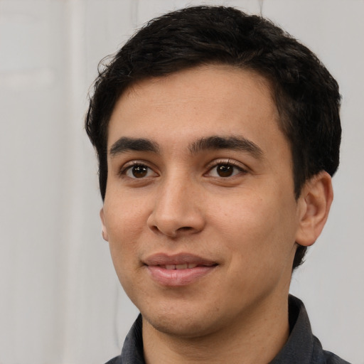 Joyful white young-adult male with short  black hair and brown eyes