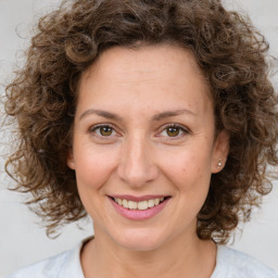 Joyful white young-adult female with medium  brown hair and green eyes