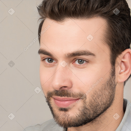 Joyful white young-adult male with short  brown hair and brown eyes