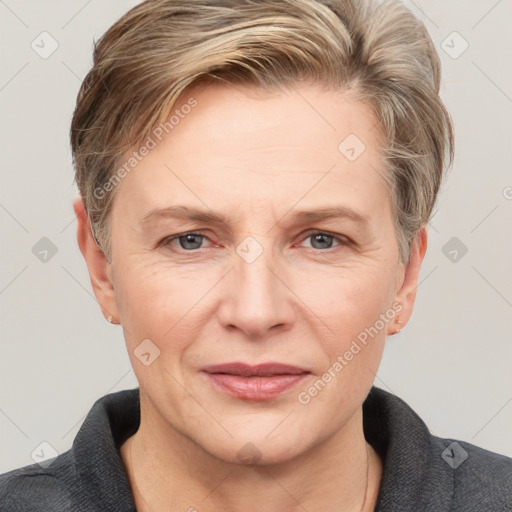 Joyful white adult female with short  brown hair and grey eyes