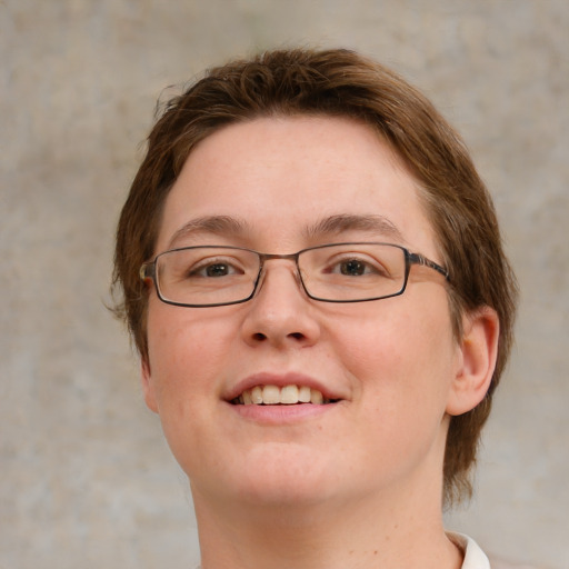 Joyful white young-adult female with short  brown hair and green eyes