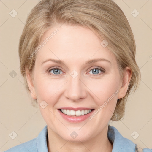 Joyful white adult female with medium  brown hair and blue eyes