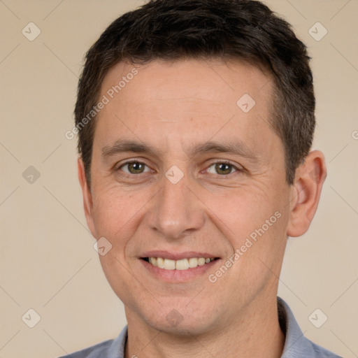 Joyful white adult male with short  brown hair and brown eyes