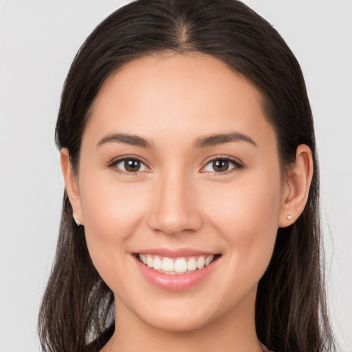 Joyful white young-adult female with long  brown hair and brown eyes