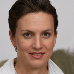 Joyful white adult female with short  brown hair and brown eyes