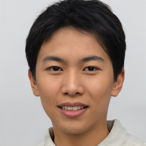 Joyful asian young-adult female with short  black hair and brown eyes