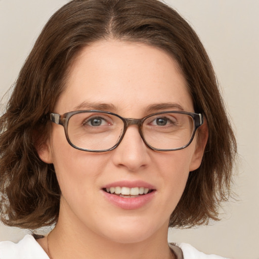 Joyful white adult female with medium  brown hair and green eyes