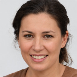 Joyful white adult female with medium  brown hair and brown eyes