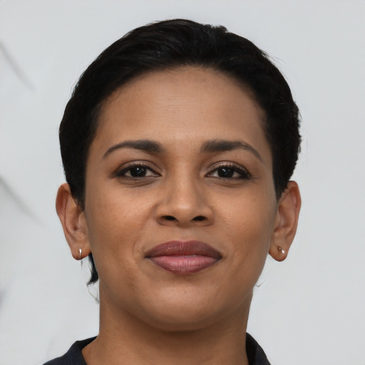 Joyful latino young-adult female with short  black hair and brown eyes