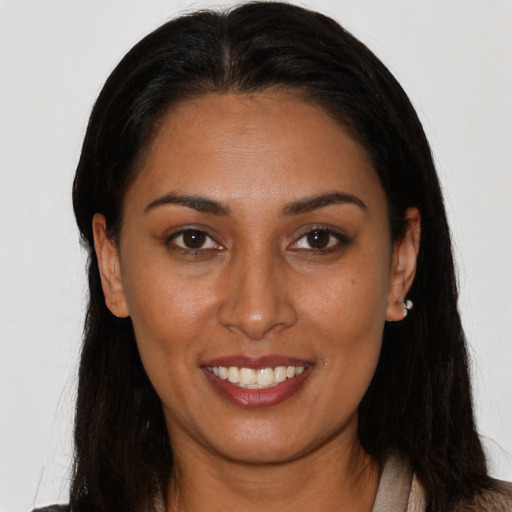 Joyful latino young-adult female with long  brown hair and brown eyes