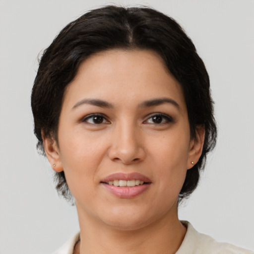 Joyful latino young-adult female with medium  brown hair and brown eyes