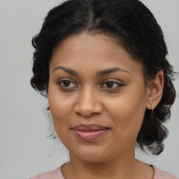 Joyful black young-adult female with medium  brown hair and brown eyes