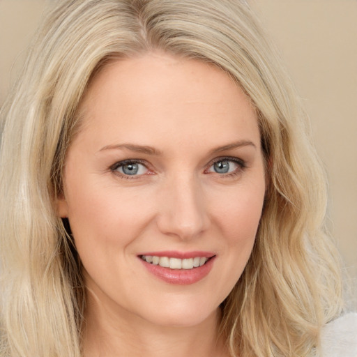 Joyful white young-adult female with long  brown hair and blue eyes