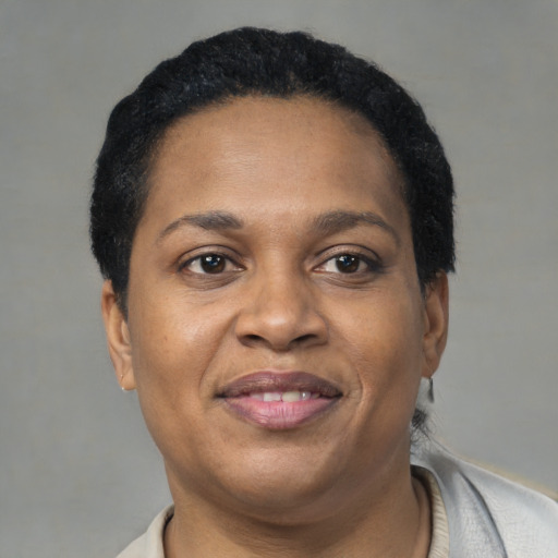 Joyful black adult female with short  brown hair and brown eyes