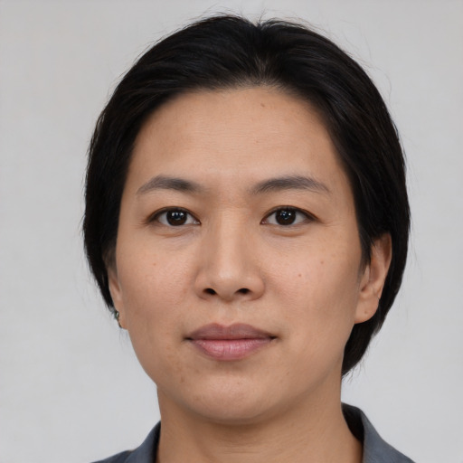 Joyful asian young-adult female with medium  black hair and brown eyes