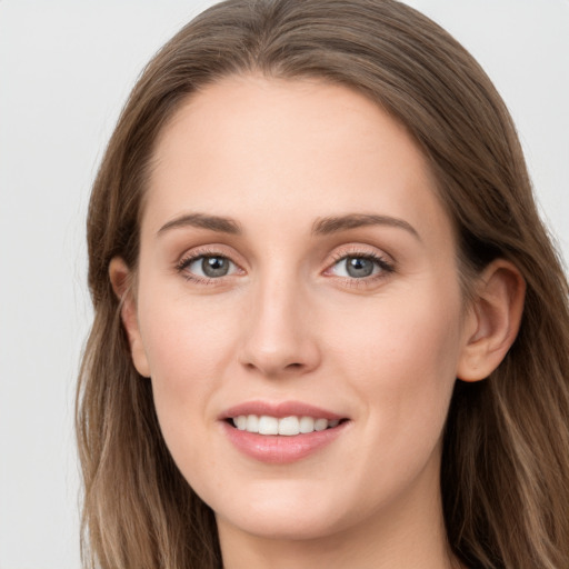 Joyful white young-adult female with long  brown hair and grey eyes