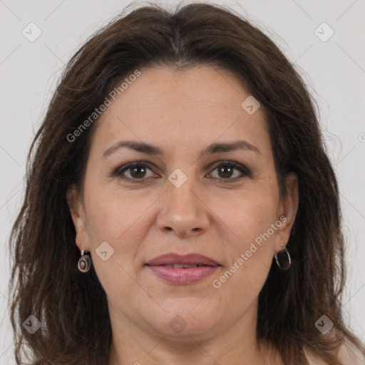 Joyful white adult female with long  brown hair and brown eyes