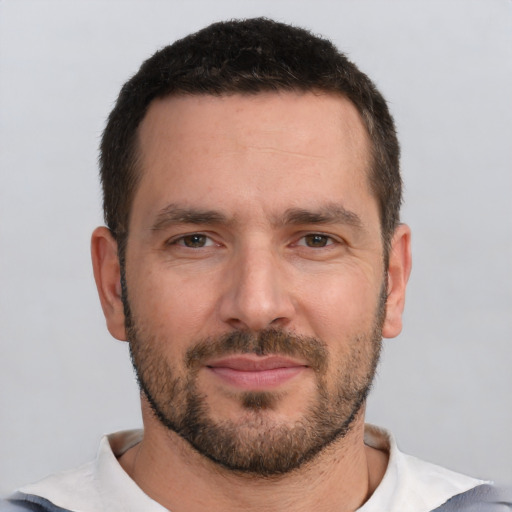 Joyful white adult male with short  brown hair and brown eyes