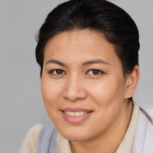 Joyful asian adult female with medium  brown hair and brown eyes