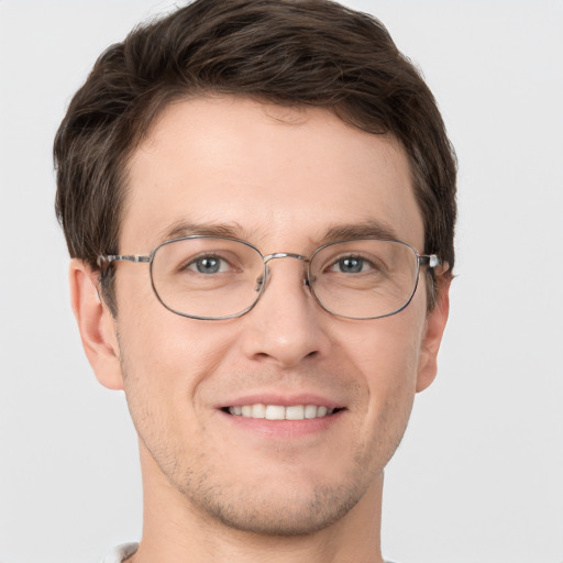 Joyful white adult male with short  brown hair and grey eyes