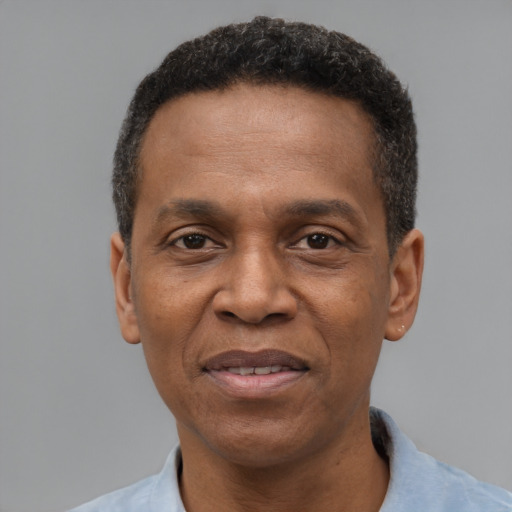 Joyful black adult male with short  black hair and brown eyes