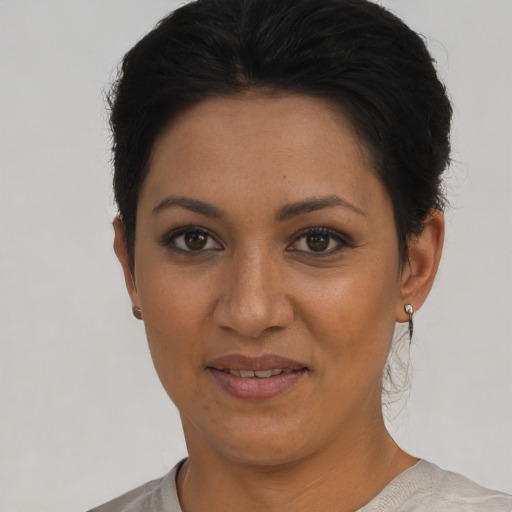 Joyful latino young-adult female with short  brown hair and brown eyes