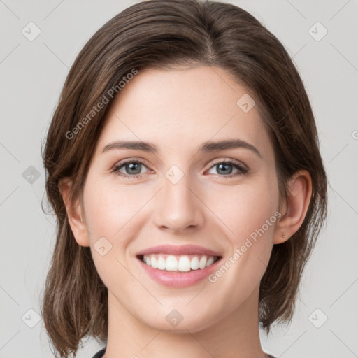 Joyful white young-adult female with medium  brown hair and green eyes