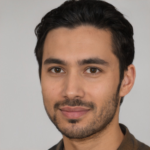 Joyful latino young-adult male with short  black hair and brown eyes