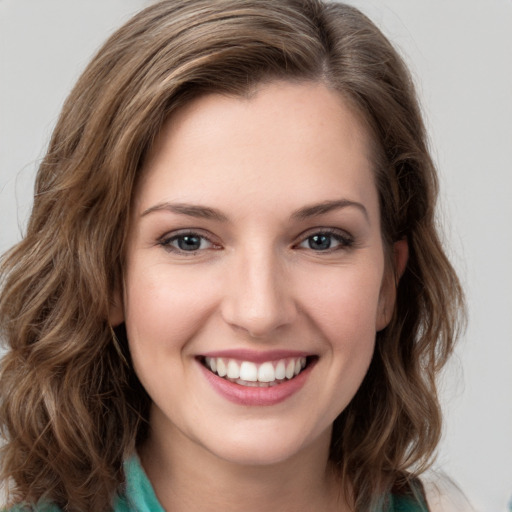 Joyful white young-adult female with medium  brown hair and green eyes