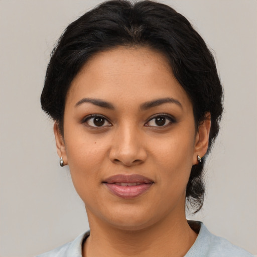Joyful latino young-adult female with medium  black hair and brown eyes