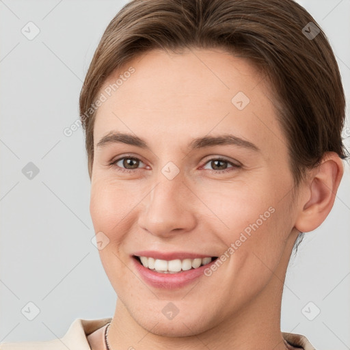 Joyful white young-adult female with short  brown hair and brown eyes