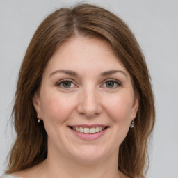 Joyful white adult female with medium  brown hair and grey eyes