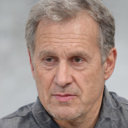 Joyful white middle-aged male with short  gray hair and brown eyes