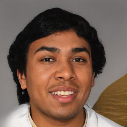 Joyful latino young-adult male with short  brown hair and brown eyes