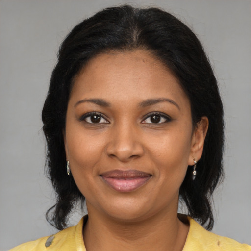 Joyful black young-adult female with medium  brown hair and brown eyes