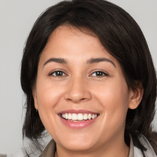 Joyful white young-adult female with medium  brown hair and brown eyes